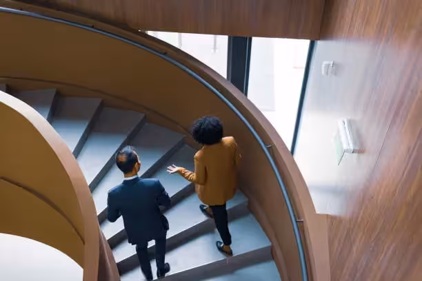 Two officials in discussion inside an institutional building